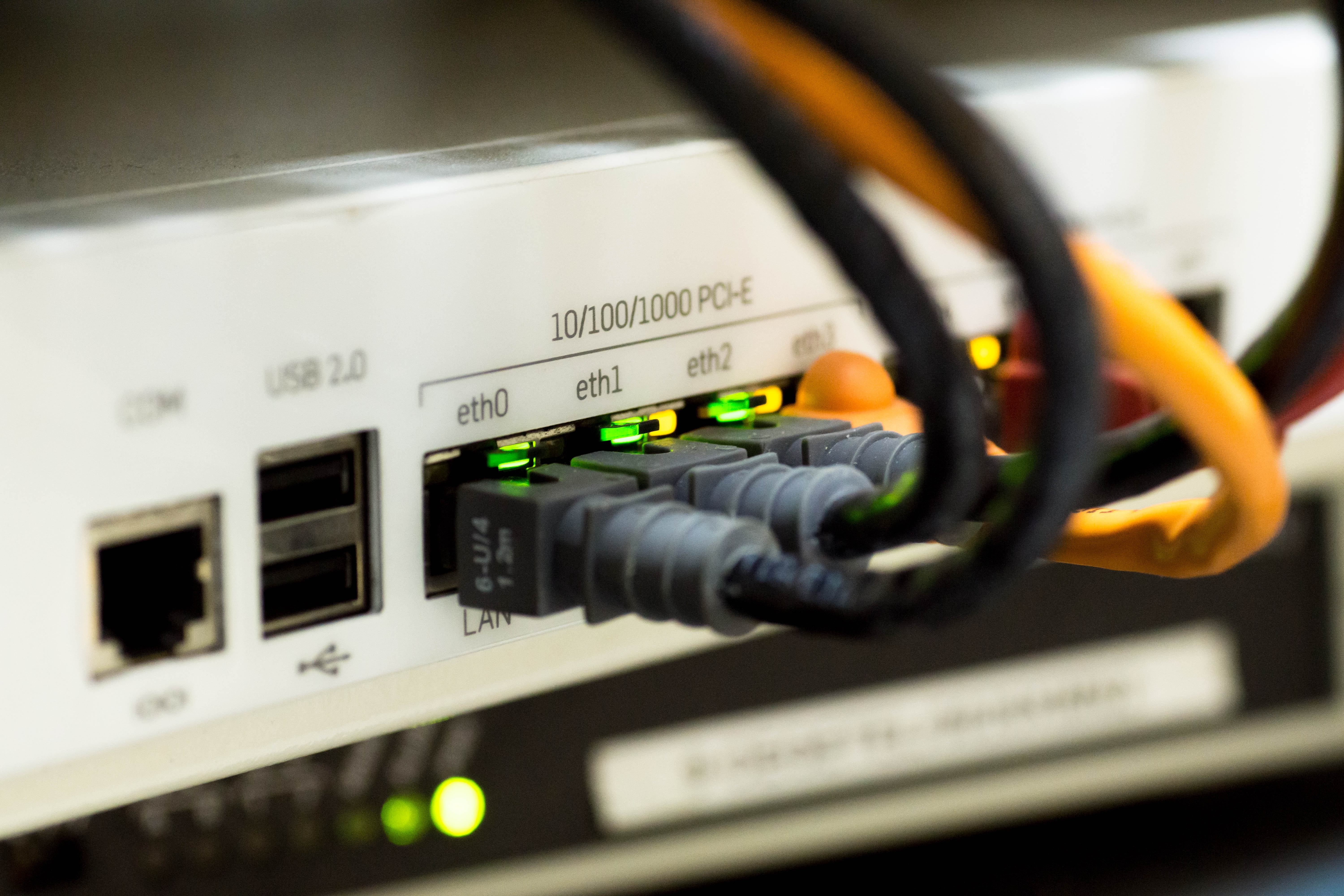 Multiple ethernet cables plugged into a router to access high-speed broadband Internet
